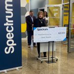 Spectrum legislative affairs representatives presenting a $20,000 Spectrum Digital Education grant check to Intergenerational Tech Inc